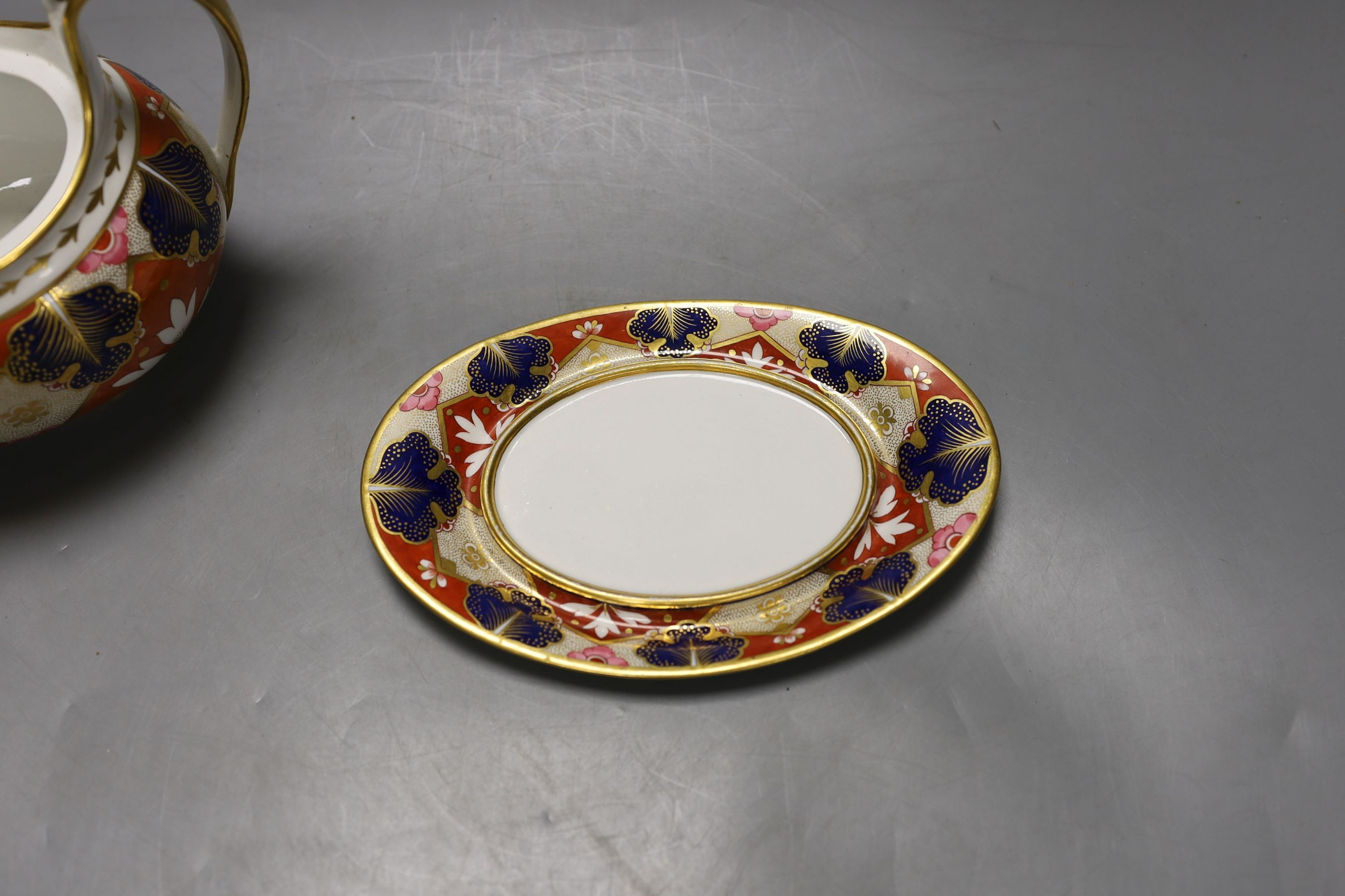 A Barr Flight and Barr Worcester teapot cover and stand painted with an Imari pattern, c.1805, 23 cm long